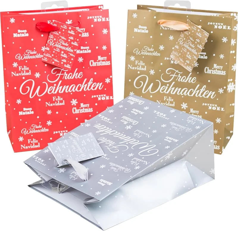 Besuche den Heku-Store HEKU Geschenktaschen-Set, Glitter 'Merry X-Mas' Design I 24 Stück in 3 Farben (Rot, Gold, Silber) I Praktische Größe (23x18x10 cm) I Inklusive kleinem Klappkärtchen für persönliche Nachrichten — Geschenkverpackung